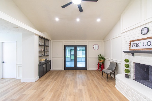 11523 Bandlon Dr, Houston, TX 77072 - living area featuring a decorative wall, light wood-style flooring, a ceiling fan, a brick fireplace, and lofted ceiling