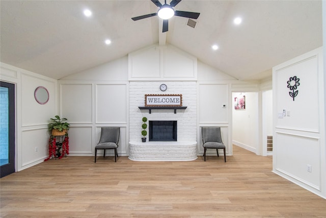 11523 Bandlon Dr, Houston, TX 77072 - living area featuring a decorative wall, a ceiling fan, a brick fireplace, light wood-type flooring, and lofted ceiling