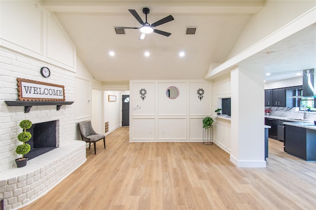 11523 Bandlon Dr, Houston, TX 77072 - unfurnished living room featuring a decorative wall, a brick fireplace, ceiling fan, light wood finished floors, and high vaulted ceiling