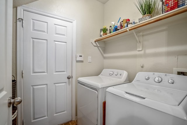18605 Syndee Loch Ct, Spring, TX 77379 - laundry area with washing machine and clothes dryer and a textured wall