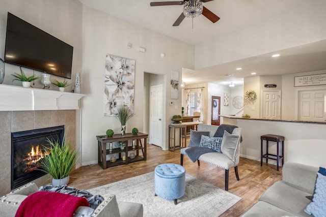 18605 Syndee Loch Ct, Spring, TX 77379 - living area with a fireplace, ceiling fan, wood finished floors, and a towering ceiling