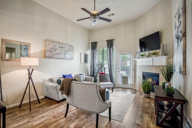 18605 Syndee Loch Ct, Spring, TX 77379 - living area with wood-type flooring, a ceiling fan, and a tile fireplace
