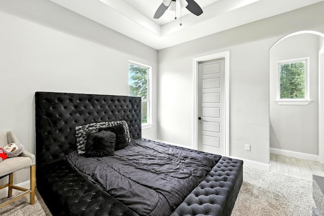 17114 Leon Ct, Splendora, TX 77372 - bedroom with multiple windows, a raised ceiling, and ceiling fan