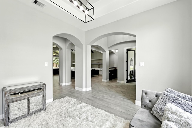 17114 Leon Ct, Splendora, TX 77372 - living area featuring arched walkways, wood finished floors, and a chandelier