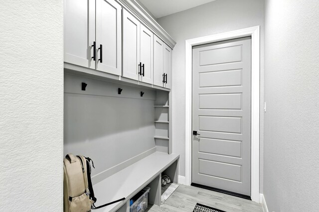 17114 Leon Ct, Splendora, TX 77372 - mudroom featuring light wood-type flooring and a textured wall