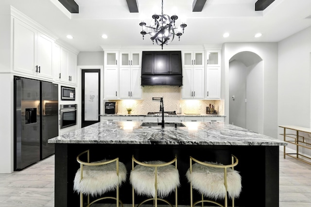17114 Leon Ct, Splendora, TX 77372 - kitchen featuring appliances with stainless steel finishes, recessed lighting, backsplash, light wood-type flooring, and light stone countertops