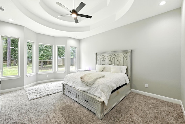 17114 Leon Ct, Splendora, TX 77372 - bedroom with multiple windows, carpet flooring, recessed lighting, a ceiling fan, and a raised ceiling