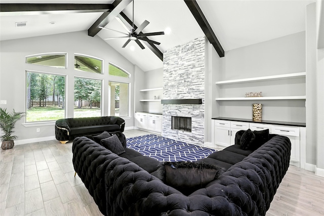 17114 Leon Ct, Splendora, TX 77372 - living room featuring beam ceiling, ceiling fan, a fireplace, built in shelves, and light wood-type flooring