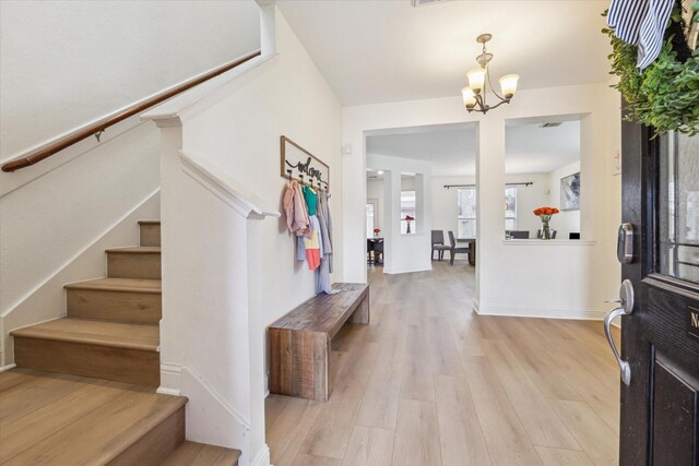 4206 Brazos Bend Dr, Pearland, TX 77584 - entryway with stairs, a chandelier, and light wood-style flooring