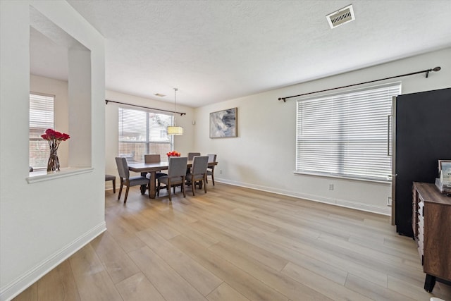 4206 Brazos Bend Dr, Pearland, TX 77584 - dining room featuring light wood-style floors and a textured ceiling