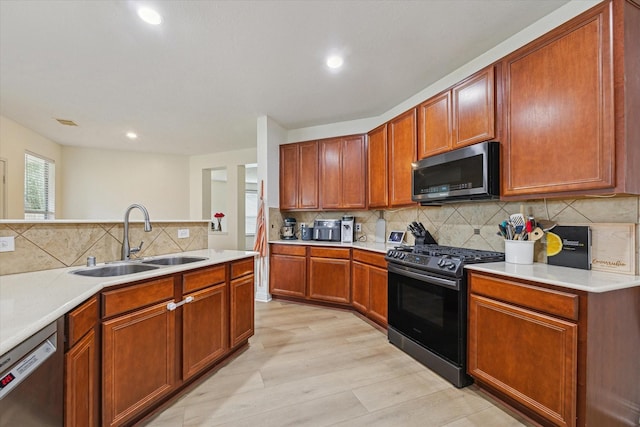 4206 Brazos Bend Dr, Pearland, TX 77584 - kitchen featuring stainless steel appliances, light wood-style floors, tasteful backsplash, light countertops, and recessed lighting