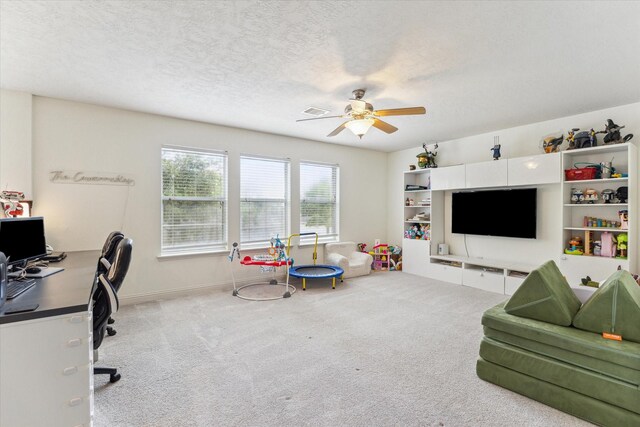 4206 Brazos Bend Dr, Pearland, TX 77584 - living room featuring a ceiling fan, a desk, carpet, and a textured ceiling