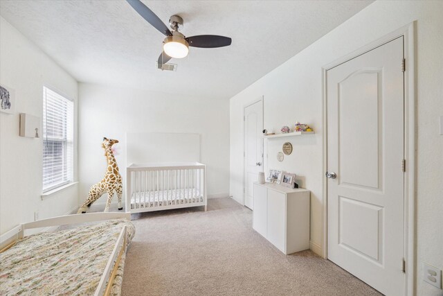 4206 Brazos Bend Dr, Pearland, TX 77584 - bedroom featuring light carpet, a nursery area, and ceiling fan