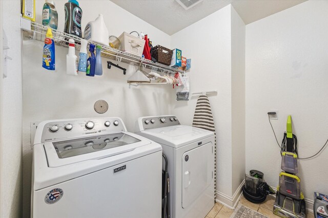 4206 Brazos Bend Dr, Pearland, TX 77584 - laundry area featuring washer and clothes dryer and light tile patterned flooring