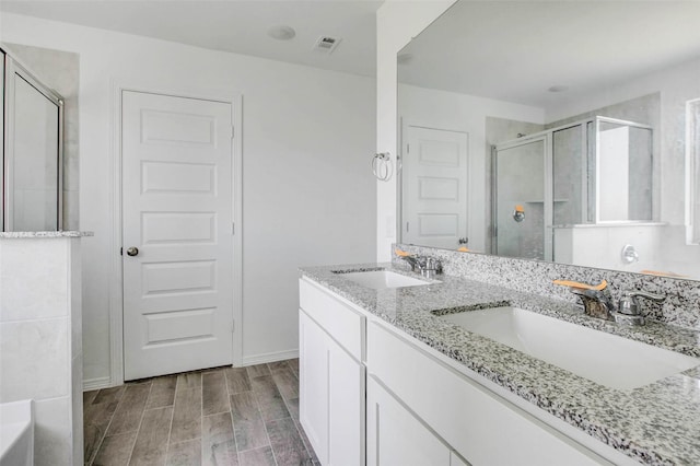22351 Auburn Cabin Ln, Porter, TX 77365 - full bath featuring a shower stall, double vanity, a tub to relax in, and wood finish floors