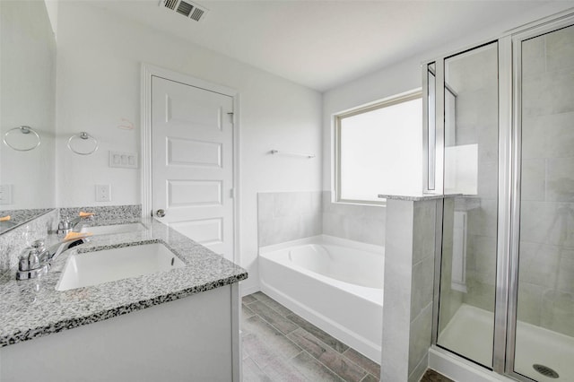 22351 Auburn Cabin Ln, Porter, TX 77365 - bathroom featuring vanity, a bath, a shower stall, and wood finished floors