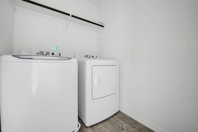 22351 Auburn Cabin Ln, Porter, TX 77365 - laundry area with washing machine and dryer and wood finish floors