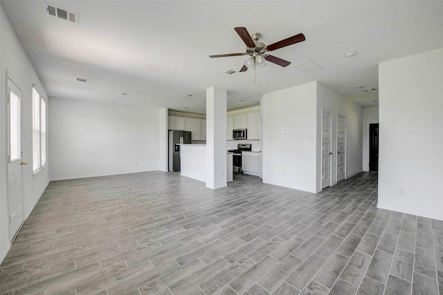 22351 Auburn Cabin Ln, Porter, TX 77365 - unfurnished living room with light wood-type flooring and a ceiling fan
