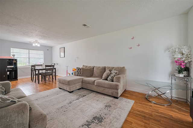13351 Oak Leaf Ln, Houston, TX 77015 - living room featuring wood finished floors and a textured ceiling