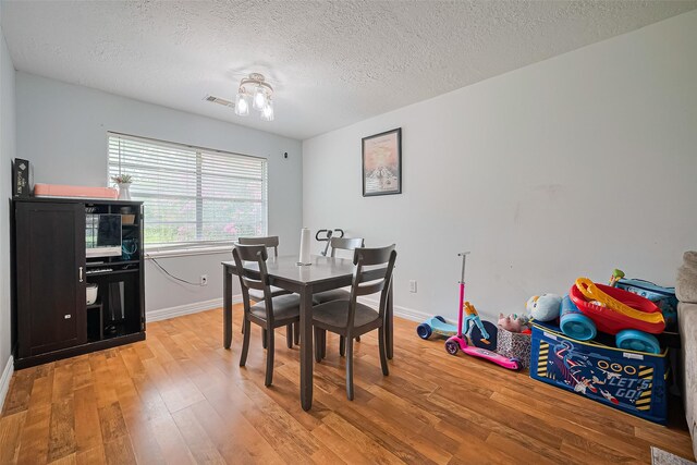 13351 Oak Leaf Ln, Houston, TX 77015 - dining room featuring light wood-style flooring and a textured ceiling