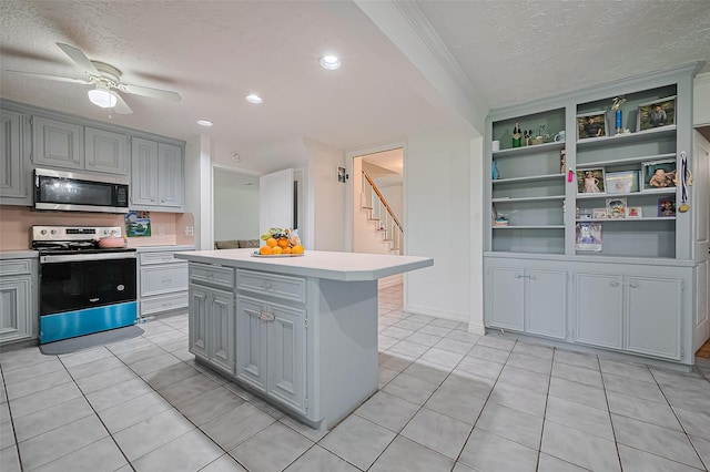 13351 Oak Leaf Ln, Houston, TX 77015 - kitchen featuring stainless steel appliances, a textured ceiling, gray cabinetry, light countertops, and a ceiling fan