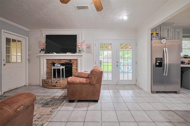 13351 Oak Leaf Ln, Houston, TX 77015 - living room with a ceiling fan, french doors, a textured ceiling, light tile patterned flooring, and ornamental molding