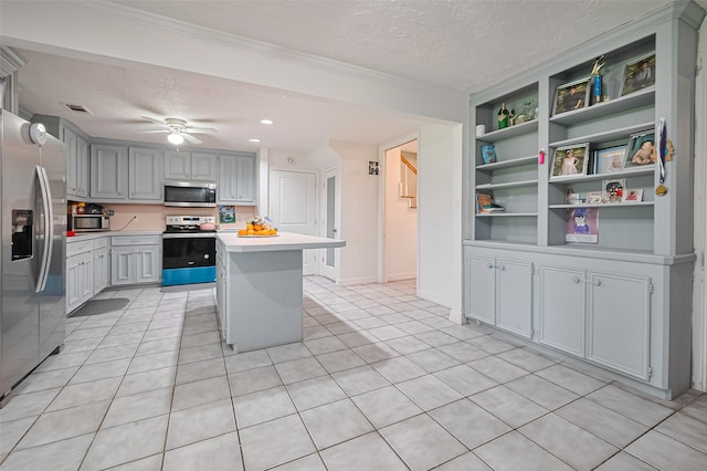 13351 Oak Leaf Ln, Houston, TX 77015 - kitchen with appliances with stainless steel finishes, a textured ceiling, light countertops, built in features, and light tile patterned floors