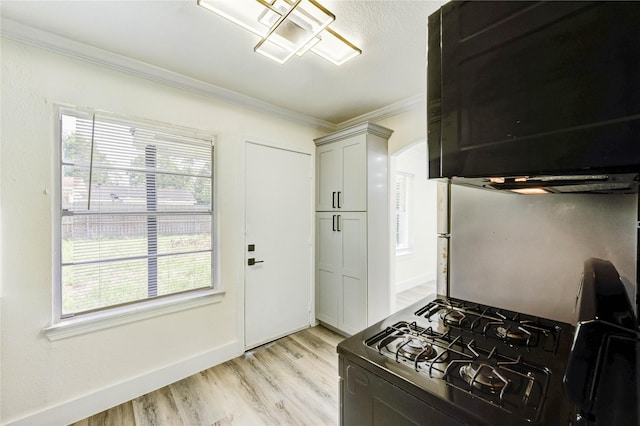 5326 Keystone St, Houston, TX 77021 - kitchen with black range with gas cooktop, ornamental molding, light wood-type flooring, and plenty of natural light