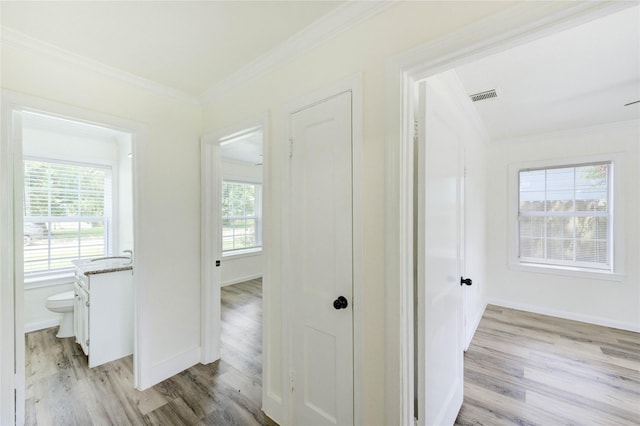 5326 Keystone St, Houston, TX 77021 - hall featuring light wood finished floors, plenty of natural light, and crown molding