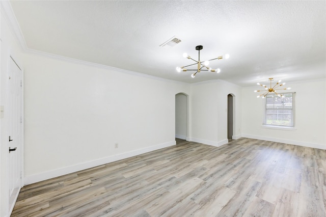 5326 Keystone St, Houston, TX 77021 - empty room with a chandelier, arched walkways, light wood-style flooring, and ornamental molding