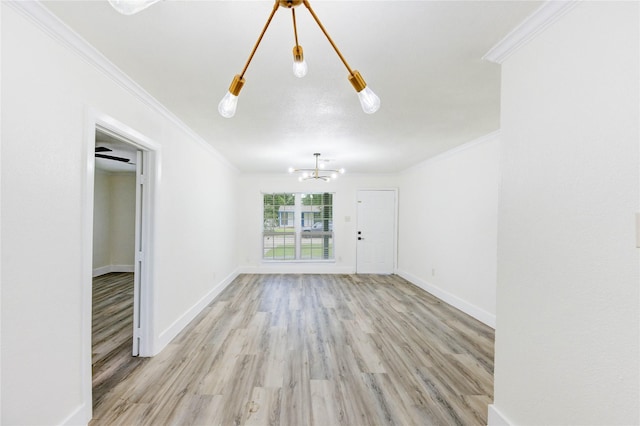 5326 Keystone St, Houston, TX 77021 - unfurnished living room with ornamental molding, light wood-style floors, and a chandelier