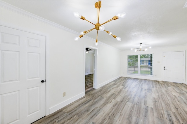 5326 Keystone St, Houston, TX 77021 - unfurnished living room featuring a chandelier, ornamental molding, and light wood-style floors