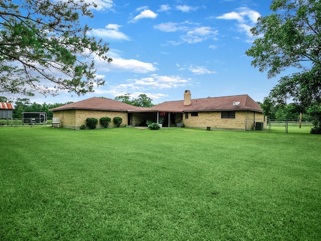 413 Christensen Rd, Hankamer, TX 77560 - back of property featuring a chimney and brick siding