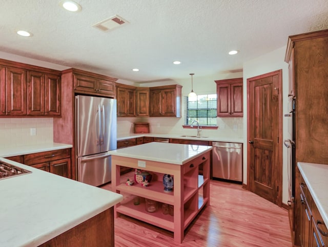 413 Christensen Rd, Hankamer, TX 77560 - kitchen featuring stainless steel appliances, open shelves, light countertops, light wood finished floors, and recessed lighting
