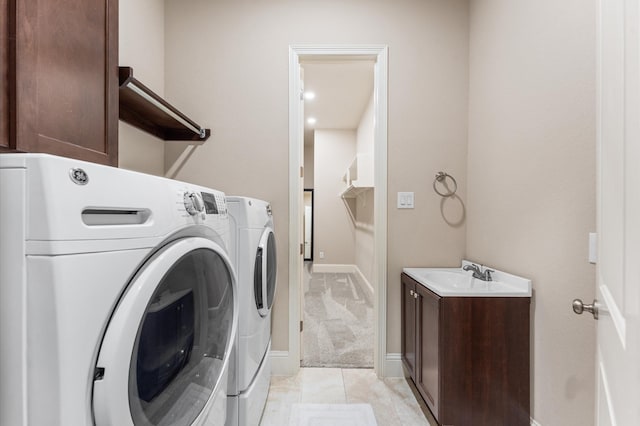 13207 Parkway Meadows Dr, Houston, TX 77077 - washroom featuring washer and clothes dryer, cabinet space, light carpet, and light tile patterned floors