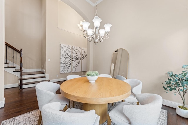 13207 Parkway Meadows Dr, Houston, TX 77077 - dining room with arched walkways, dark wood-style flooring, a chandelier, and stairs