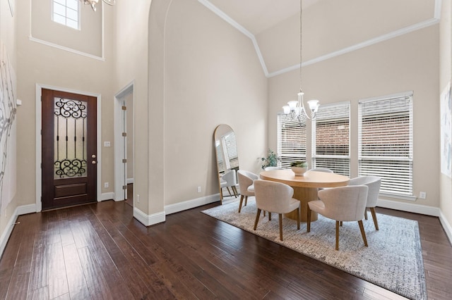 13207 Parkway Meadows Dr, Houston, TX 77077 - dining space with a chandelier, high vaulted ceiling, dark wood finished floors, arched walkways, and crown molding