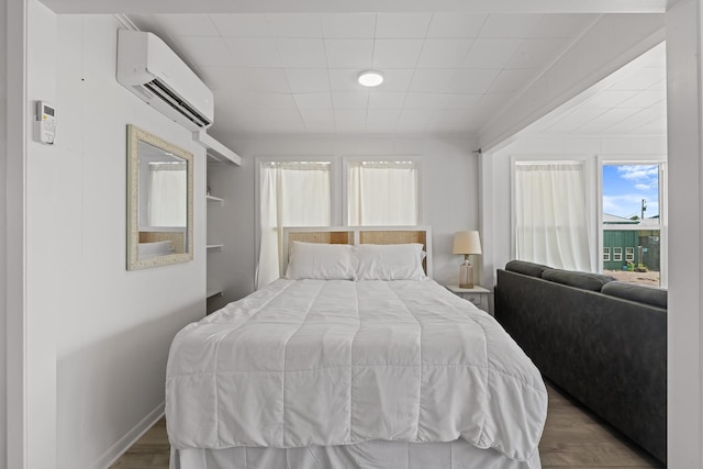 106 E Madison Ave, Port O Connor, TX 77982 - bedroom with a wall unit AC and wood finished floors