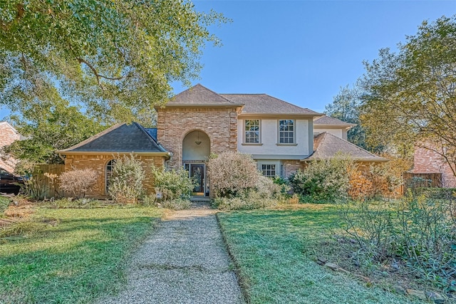 1903 Wagon Gap Trl, Houston, TX 77090 - french country inspired facade featuring a front yard, brick siding, and stucco siding