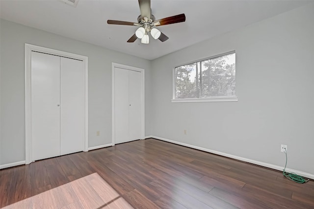 1903 Wagon Gap Trl, Houston, TX 77090 - unfurnished bedroom featuring two closets, wood finished floors, and ceiling fan