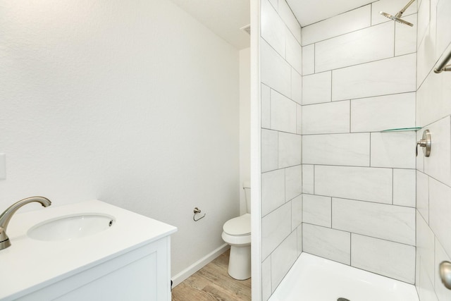 344 Thunder Rd, Surfside Beach, TX 77541 - bathroom with wood finished floors, tiled shower, and vanity