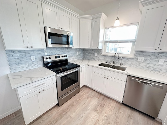 344 Thunder Rd, Surfside Beach, TX 77541 - kitchen featuring stainless steel appliances, decorative backsplash, and light wood-style flooring