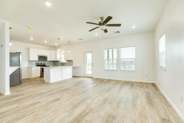 344 Thunder Rd, Surfside Beach, TX 77541 - kitchen featuring appliances with stainless steel finishes, open floor plan, backsplash, ceiling fan, and light countertops