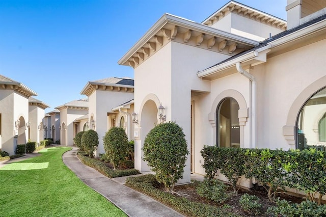 12832 Willow Centre Drive E And F, Houston, TX 77066 - view of side of home featuring stucco siding and a lawn