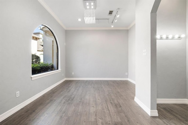 12832 Willow Centre Drive E And F, Houston, TX 77066 - unfurnished room featuring crown molding, rail lighting, wood finished floors, arched walkways, and a chandelier