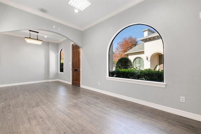 12832 Willow Centre Drive E And F, Houston, TX 77066 - empty room with wood finished floors, crown molding, arched walkways, and recessed lighting