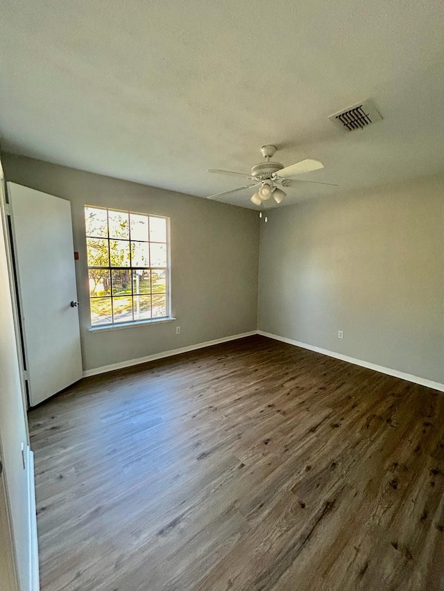 15231 Falling Creek Dr, Houston, TX 77068 - unfurnished room featuring dark wood-style flooring, a ceiling fan, and a textured ceiling