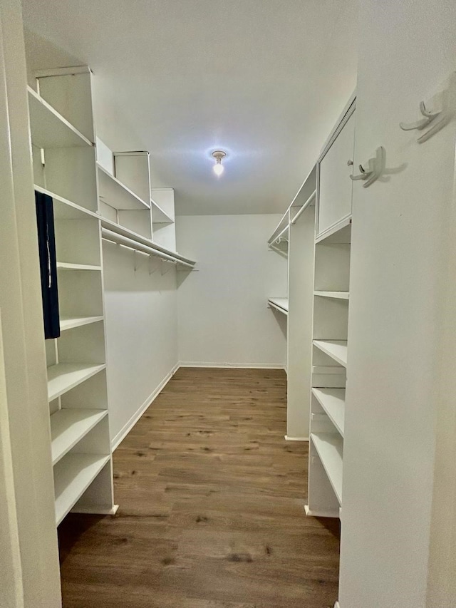 15231 Falling Creek Dr, Houston, TX 77068 - walk in closet with dark wood-style flooring
