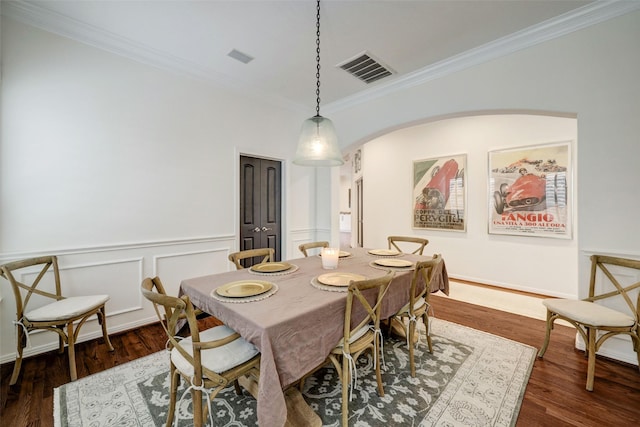 4004 Childress St, Houston, TX 77005 - dining area featuring arched walkways, crown molding, dark wood-type flooring, and wainscoting