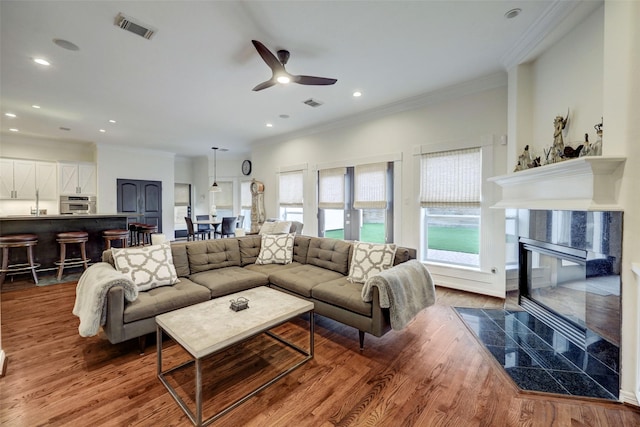 4004 Childress St, Houston, TX 77005 - living room with ornamental molding, wood finished floors, a high end fireplace, ceiling fan, and recessed lighting